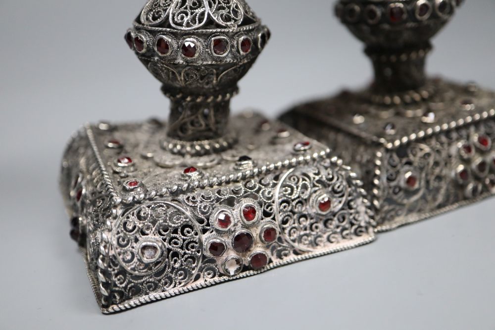 A pair of continental filligree white metal and red stone set dwarf candlesticks (possibly Malta), 11.4cm, weighted.